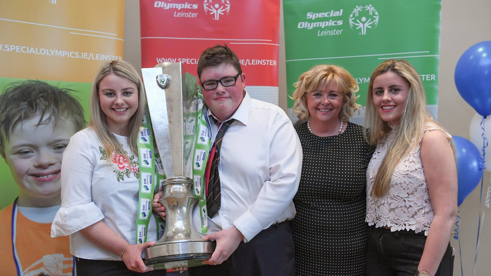 Athletes and coaches with trophy