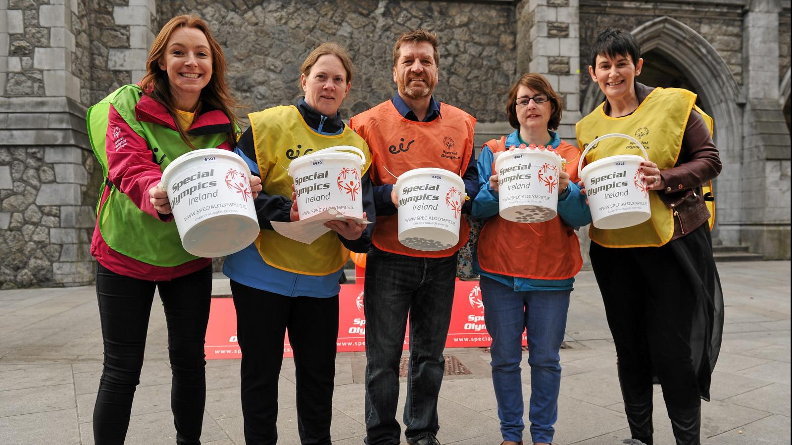 Volunteers collecting money with collection buckets